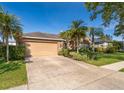 Lovely home featuring a two-car garage and well-manicured front lawn, showcasing curb appeal and inviting entrance at 402 Turnstone Way, Orlando, FL 32828
