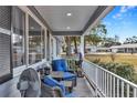 Relaxing front porch with seating area, overlooking the neighborhood at 10897 Sw 80Th Ct, Ocala, FL 34481