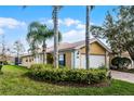 Inviting home featuring palm trees and a well-maintained lawn, enhancing its curb appeal at 11753 Fan Tail Ln, Orlando, FL 32827