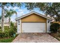 Spacious two-car garage with a brick driveway providing ample parking at 11753 Fan Tail Ln, Orlando, FL 32827