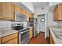 Kitchen featuring stainless steel appliances, wood cabinets, and tile floors at 13003 Plantation Park Cir # 1319, Orlando, FL 32821