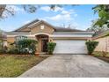 Attractive single-story home with a lush front yard and a two-car garage at 13713 Meadowpark Ave, Orlando, FL 32826