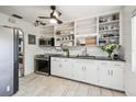 Functional kitchen with white cabinets, open shelving, modern appliances, and plenty of counter space at 1412 Nebraska St, Orlando, FL 32803