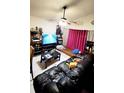 Cozy living room featuring a leather sofa, entertainment center, and tiled flooring at 1417 Brookebridge Dr, Orlando, FL 32825