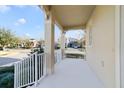 Covered front porch with white railings and a view of the street at 14502 Bahama Swallow Blvd, Winter Garden, FL 34787