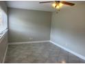 Bright bedroom featuring tiled floor, neutral walls, and a window with blinds for natural light at 158 Country Club Cir, Sanford, FL 32771