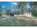 Single-story home with a carport and a tidy front lawn offers curb appeal at 1811 Oneco Ave, Winter Park, FL 32789