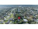 Aerial view of a home nestled in a tranquil neighborhood surrounded by mature trees at 1811 Oneco Ave, Winter Park, FL 32789