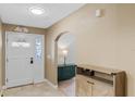 Inviting home entryway with tile flooring, archway, and ample natural light, showcasing its welcoming ambiance at 1971 Urbana Ave, Deltona, FL 32725