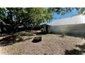 Spacious backyard with mature trees and a fire pit, perfect for outdoor entertaining at 214 N New Hampshire Ave, Tavares, FL 32778