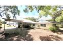 Large backyard with a covered parking area, ideal for outdoor activities and storage at 214 N New Hampshire Ave, Tavares, FL 32778