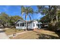 White house with palm tree and walkway at 214 N New Hampshire Ave, Tavares, FL 32778