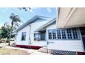 Classic home with front-facing window, trimmed in blue, offering light-filled living spaces at 214 N New Hampshire Ave, Tavares, FL 32778