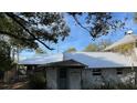 Rear view of the house, showing metal roof and stonework at 214 N New Hampshire Ave, Tavares, FL 32778