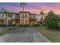 Charming townhome featuring a welcoming entrance, a neatly maintained lawn, and vibrant palm trees at 2153 Calabria Ave, Davenport, FL 33897