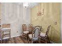 Dining area with a round glass table, four wicker chairs, and wood-look flooring at 2521 Grassy Point Dr # 309, Lake Mary, FL 32746