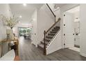 Bright entryway with modern staircase leading to the second floor and an open view into other living spaces at 4104 Southern Vista Loop, St Cloud, FL 34772