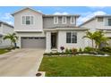 Two-story home featuring a manicured front lawn, attached two-car garage and a gray and white exterior at 4104 Southern Vista Loop, St Cloud, FL 34772