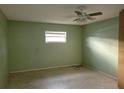 A bedroom with light green walls, ceiling fan, and tile flooring at 477 C St # 4, Casselberry, FL 32707