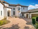 House exterior showcasing a grand entrance and attached garage at 5067 Latrobe Dr, Windermere, FL 34786