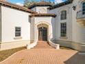 Elegant entryway with double doors and curved staircase at 5067 Latrobe Dr, Windermere, FL 34786