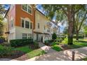 Three-story townhouses with attractive landscaping and walkway at 5409 Napoli Cv, Lake Mary, FL 32746