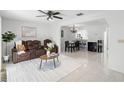 Open-concept living and dining area with sleek tile flooring and a modern ceiling fan at 564 Shadow Glenn Pl, Winter Springs, FL 32708