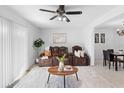 Bright living room with a ceiling fan, decorative rug, and leather sofa set at 564 Shadow Glenn Pl, Winter Springs, FL 32708