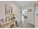 Neutral entryway with console table, decor and view of dining and living spaces at 812 Gisele Ct, Haines City, FL 33844