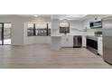 Bright kitchen features stainless steel appliances, white cabinets, and a bay window for natural light at 8546 Amber Oak Dr, Orlando, FL 32817