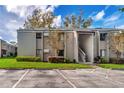 Exterior view of a well-kept condominium building with parking, landscaping, and staircase entryways at 134 Springwood Cir # A, Longwood, FL 32750