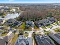 Aerial view of the property highlighting the home's location within a well-maintained neighborhood, near a lake at 16315 Bristol Lake Cir, Orlando, FL 32828