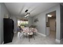 Stylish dining room with modern lighting, tiled floors, neutral paint, and backyard views at 1659 Nantucket St, Deltona, FL 32725