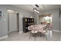 Bright dining room with decorative shelving, tiled floors, and sliding glass door access to the backyard at 1659 Nantucket St, Deltona, FL 32725