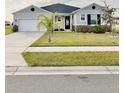 Charming single-story home with well-manicured lawn and attached two car garage at 2401 Begonia St, Mascotte, FL 34753