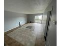 A cozy living room features tile flooring and sliding glass doors to a balcony at 243 Scottsdale Sq # 243, Winter Park, FL 32792