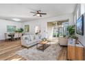 Bright living room with wood floors, stylish furniture, and sliding door to the patio at 329 Streamview Way, Winter Springs, FL 32708