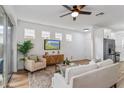 Cozy living area with a large window, comfortable seating, and a ceiling fan at 329 Streamview Way, Winter Springs, FL 32708