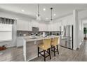 Bright kitchen with a center island, pendant lighting, and stainless steel appliances at 3563 Fernanda Dr, Deltona, FL 32738