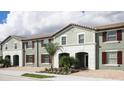 Three-unit townhome building with green exterior, and burgundy accents at 4651 Terrasonesta Dr, Davenport, FL 33837