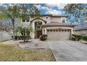 Charming home with a two-car garage and a beautifully landscaped front yard at 4941 Casa Vista Dr, Orlando, FL 32837