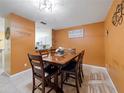 Inviting dining room features a dark wood table, seating for six, and tiled floors at 5409 Caramella Dr, Orlando, FL 32829