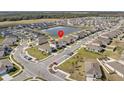 Aerial view of the neighborhood with pond; the property is marked with a red icon at 5654 Winona Dr, St Cloud, FL 34771