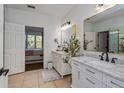 Bathroom featuring double sinks, elegant mirrors, and stylish decor at 6443 Axeitos Ter # 105, Orlando, FL 32835