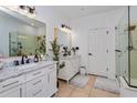 Bright bathroom with double vanity, modern fixtures, and decorative plants at 6443 Axeitos Ter # 105, Orlando, FL 32835