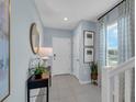 Inviting entryway with tile flooring, console table, and stylish decor at 1327 Fan Palm Dr, Davenport, FL 33897