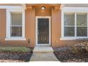 Inviting front entrance flanked by windows and complemented by manicured greenery at 15319 Oak Apple Ct, Winter Garden, FL 34787