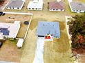 Aerial view of home featuring a dark gray roof and freshly planted landscaping with a paved driveway at 15657 Sw 37Th Cir, Ocala, FL 34473