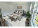 Cozy main bedroom featuring a large bed, neutral decor, and ample natural light from the window at 15657 Sw 37Th Cir, Ocala, FL 34473