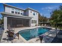 Beautiful kidney shaped pool with a screened patio dining area, as well as lounge seating on a paver patio at 15732 Shorebird Ln, Winter Garden, FL 34787